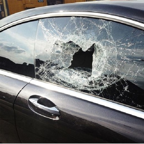 fixing a broken car window with tape